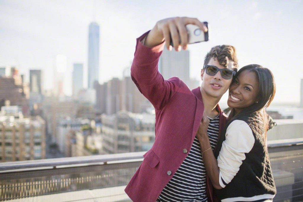 Couple taking selfie on rooftop
