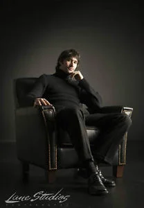 guy-in-chair-and-logo